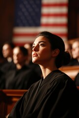 Judge listens intently in courtroom with the American flag, with other judges