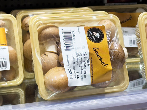 Fresh gourmet chestnut mushrooms in plastic packaging on store shelf