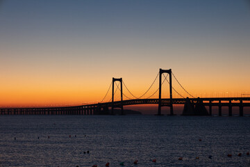 Sunrise Over Xinghai Bay Bridge: A Golden Morning