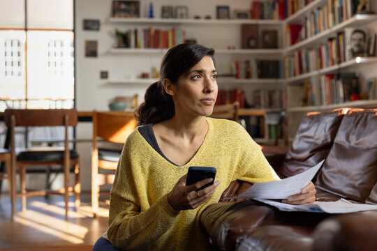 Worried woman paying bills online