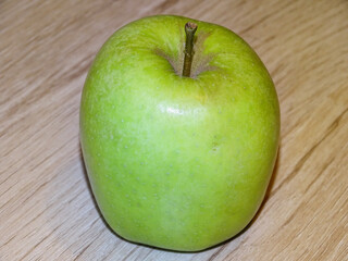 Green apple on a wooden background