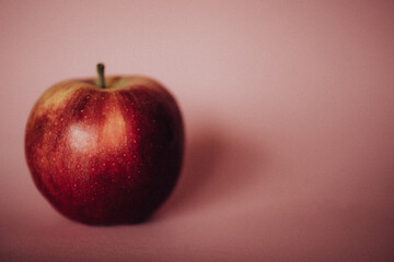 Red apple on a pink background