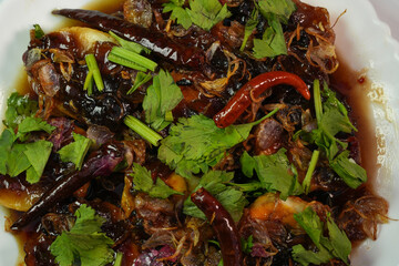 A favorite food for Thai people is Kai Luk Khoi, which is made by frying boiled eggs and sprinkling them with caramel.