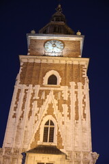 tower of the church. scenic view of city in the evening lights. landscape of the old town street. people like to walk along the historical part of the city.