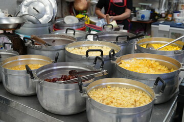In the market, there are large pots of sweets for sale.