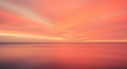 Sunset over a calm sea in red and pink colors with blurred motion long exposure.