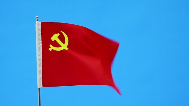 Flag of the Chinese Communist Party waving on blue sky background, slow motion video