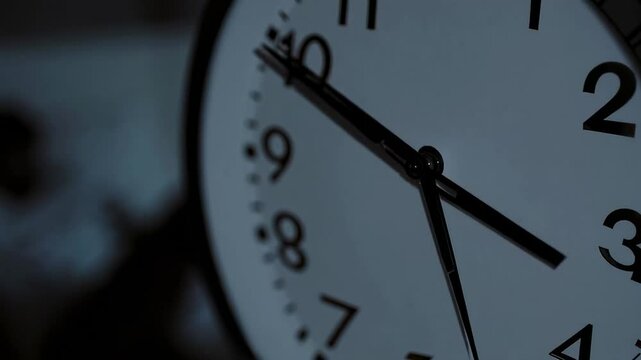 Mechanical clock hands moving across dial, revealing temporal progression through rhythmic slow motion timelapse capturing intricate movement against minimal background