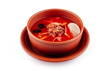 Russian traditional solyanka soup with meat and lemon in bowl