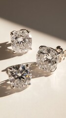 Elegant diamond jewelry trio reflecting sunlight on smooth surface