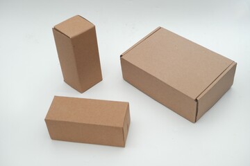 Set of plain brown cardboard boxes in different sizes on a white background, ideal for packaging,...