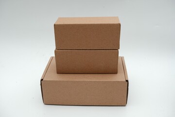 Set of plain brown cardboard boxes in different sizes on a white background, ideal for packaging, shipping, and storage.