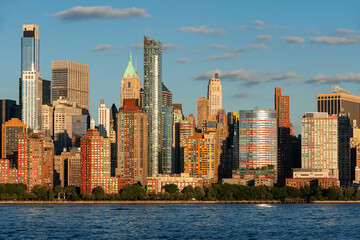 Obraz premium Afternoon light on Battery Park and Lower Manhattan skyscrapers in New York City. Metropolitan cityscape from the Hudson River