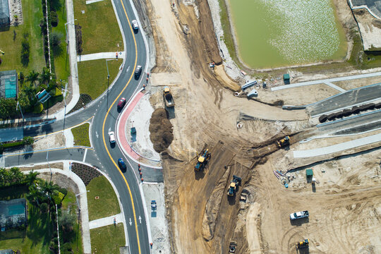 Aerial view of busy American highway road under construction. Development of roundabout traffic infrastructure. State transportation concept