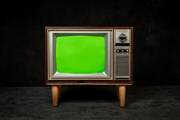Retro old television with chroma key green screen standing in a dark room, antique and vintage TV...