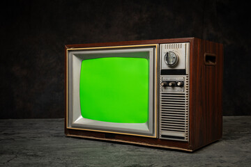 Retro old television with chroma key green screen in dark room, antique and vintage TV.