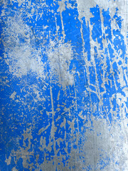 Worn blue paint on metal sheet texture background. Old blue concrete surface. Blue enamel paint is...