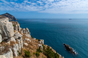 tranquil seascape with cliff and rock