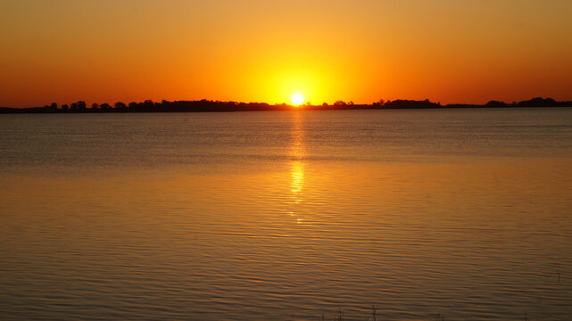 Landscape view of a beautiful sunset over Chascomus lake, Buenos Aires        