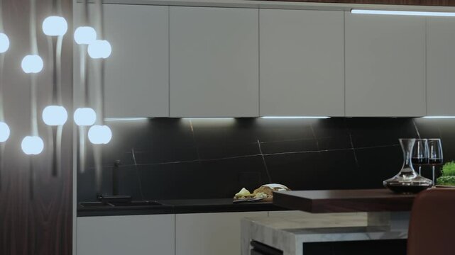 A modern kitchen with stylish pendant lighting that emphasizes its elegance. Stylish interior 