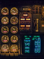 Close-up of an illuminated aircraft cockpit engine control panel at night. High quality photo