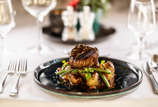 Fillet steak of beef, saut�ed green beans with bacon, jacket potatoes and green pepper sauce
