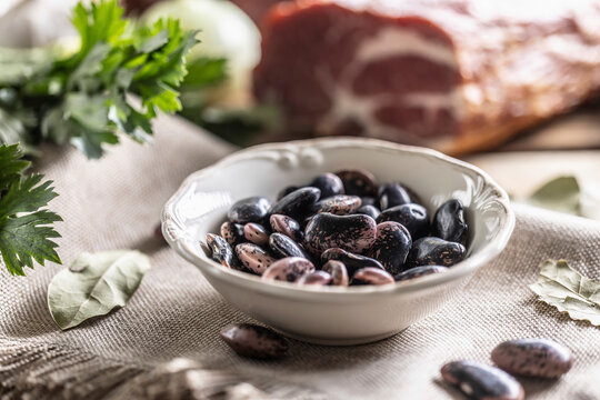 Beetle beans in a bowl and smoked pork neck in the background