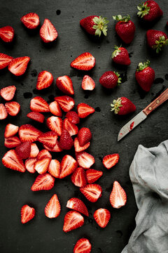 Freshly washed whole and halved strawberries