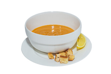 pumpkin soup in a white bowl isolated on a white background