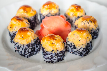 Sushi rolls on a white plate, close-up, selective focus