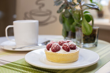  Lemon tart with raspberries and a cup of coffee
