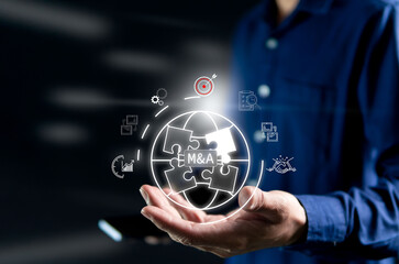 Mergers and acquisitions increased bargaining power in the global market Hologram white light icon placed on businessman's hand. Add white light and soft blur background.