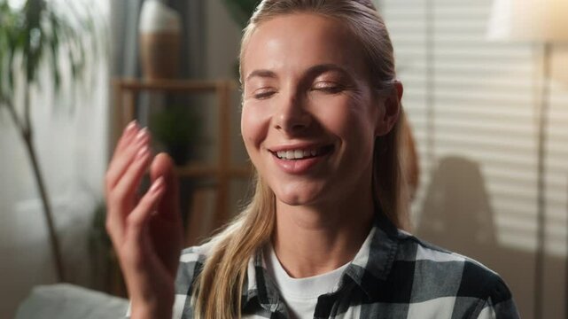 Portrait indoors at home happy funny smiling joyful positive Caucasian woman adult female girl lady homeowner looking at camera laughing smile joke fun humorous reaction amazed close mouth with hand