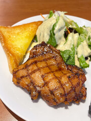 Delicious grilled chicken with salad and pastry.