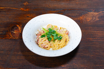 Delicious pasta dish served in a bowl on wooden table