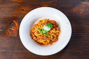 Delicious spaghetti served on a rustic wooden table