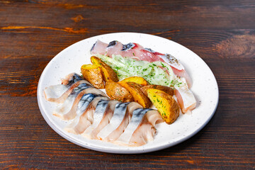 Delicious seafood and roasted potatoes served on a white plate