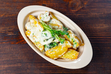 Delicious cheesy broccoli and potato dish served in a bowl