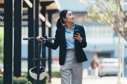 Professional female rider gripping electric scooter, navigating urban landscape through smartphone app, representing eco-friendly urban mobility
