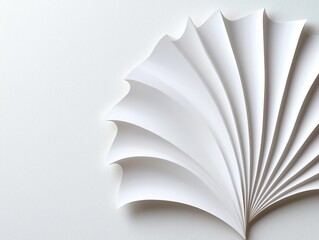 A delicate white paper fan with folded sections, creating a graceful design on a light background.