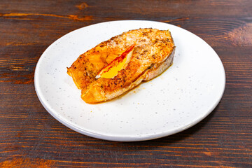 Freshly cooked salmon filet served on a white plate