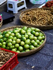 Green lemons in local market 