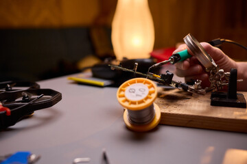Hands Carefully Repairing a Circuit Board with a Soldering Tool for Electronics Projects