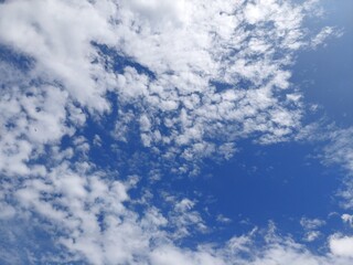 white cloud under sunny blue sky shot in the middle of the day