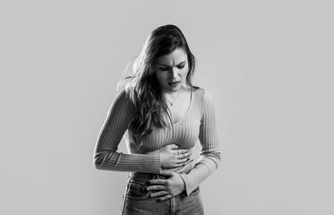 Young unhappy unwell sick ill woman hold hand on stomach suffers pain pms. Stomach pain and others...
