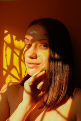 the girl's painted face is smiling