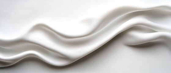 Obraz premium A smooth, flowing white fabric drapes elegantly, showcasing its soft texture and gentle curves.