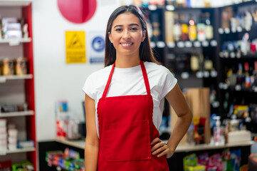 Latina woman, grocery store worker, performs different tasks inside the store. Portrait of...