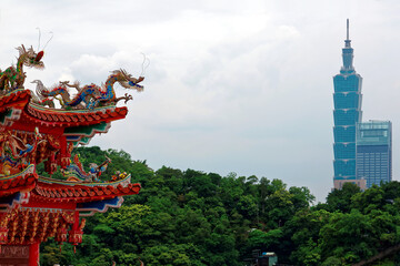 View of the colorful eaves of a Taiwanese temple decorated with delicate & fancy sculptures (dragon...