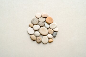 Natural elegance emerges from the arrangement of smooth stones creating a harmonious circle on a clean surface